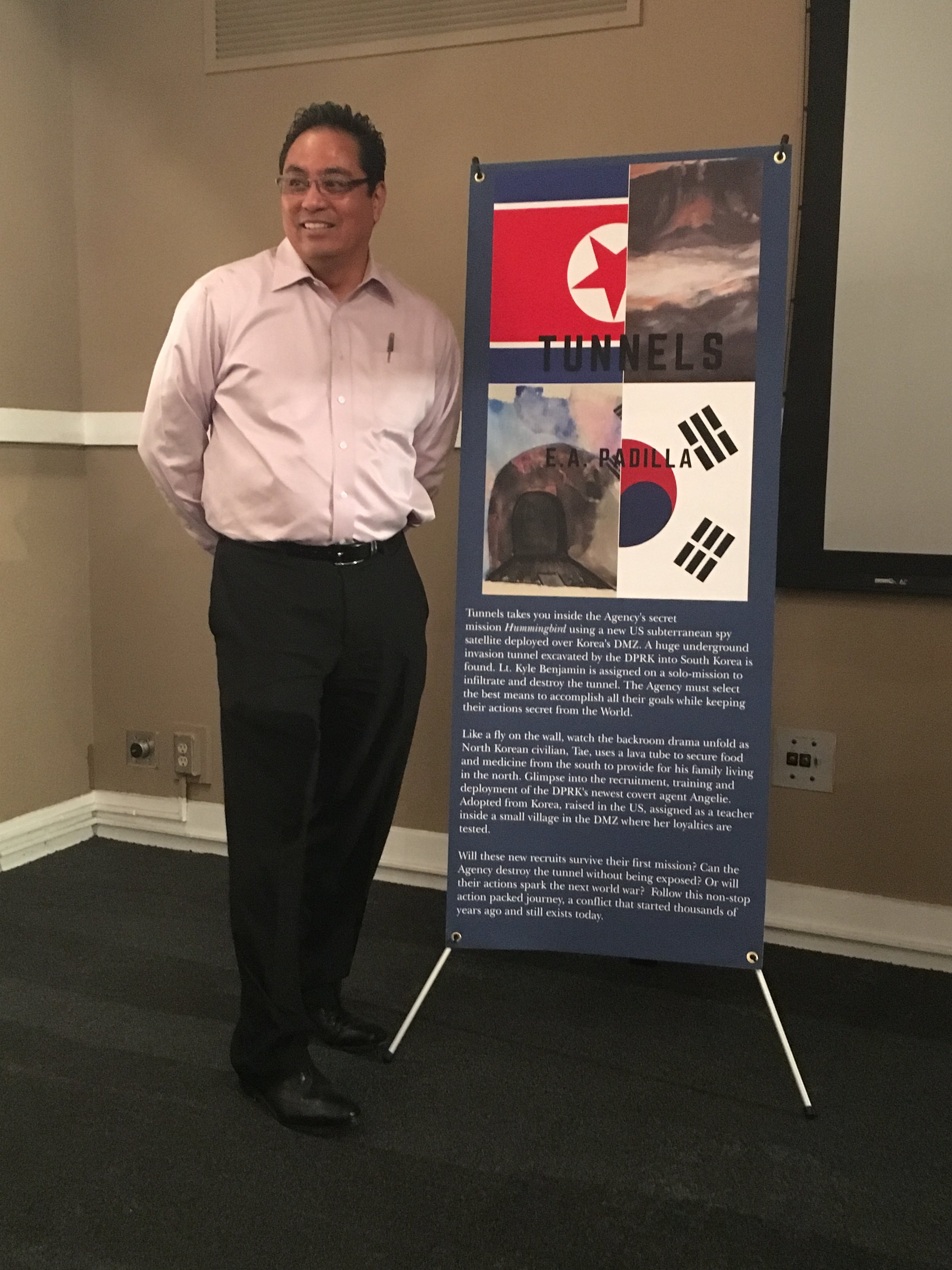 Standing by banner.JPG