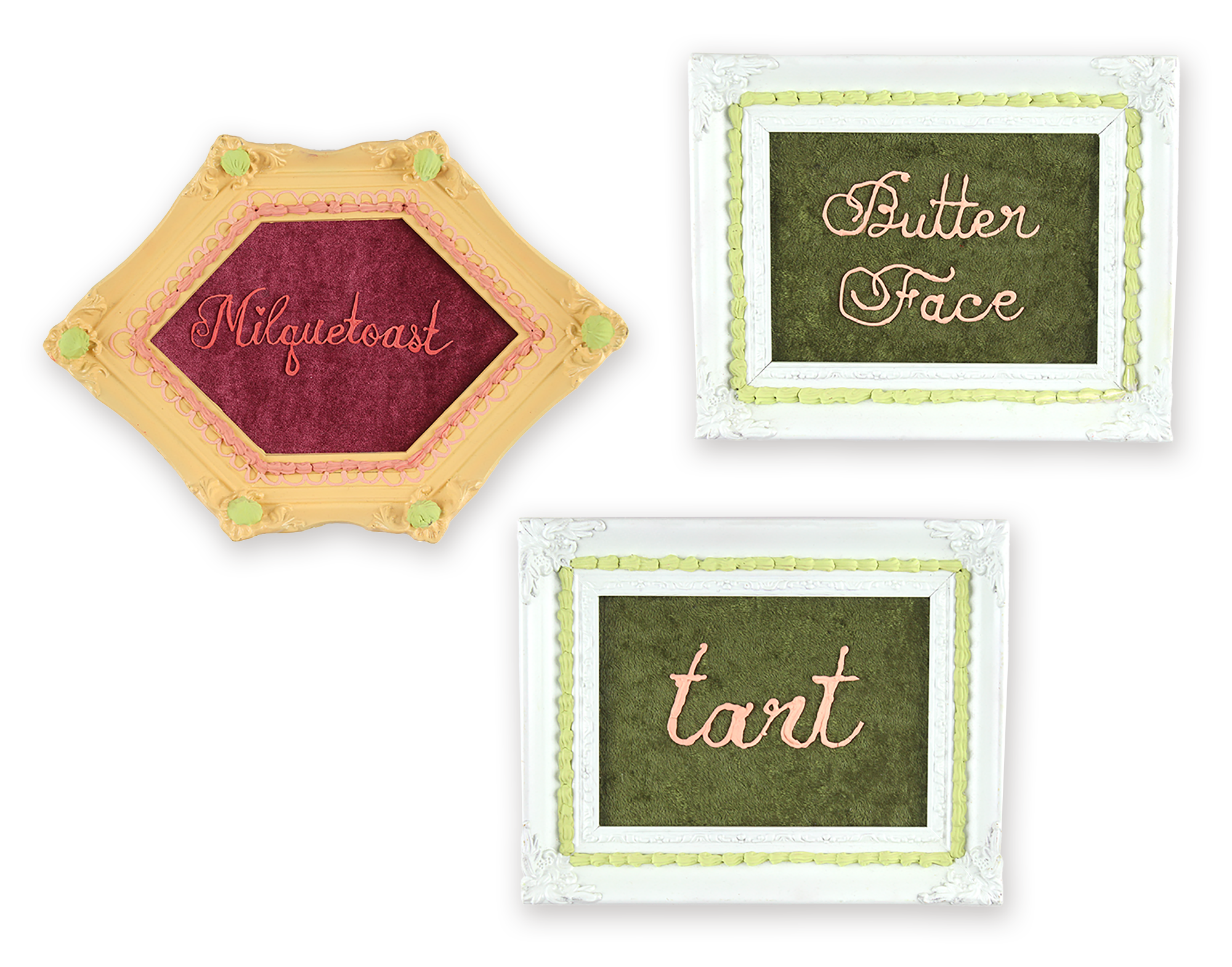 A grouping of three mixed-media pieces featuring the words Milquetoast, Butter Face, and tart in pink script over velvet, enclosed in frosted cake-style frames. Art installation by Laura Shull.