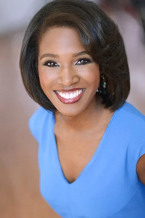 Woman in blue shirt posing for photo