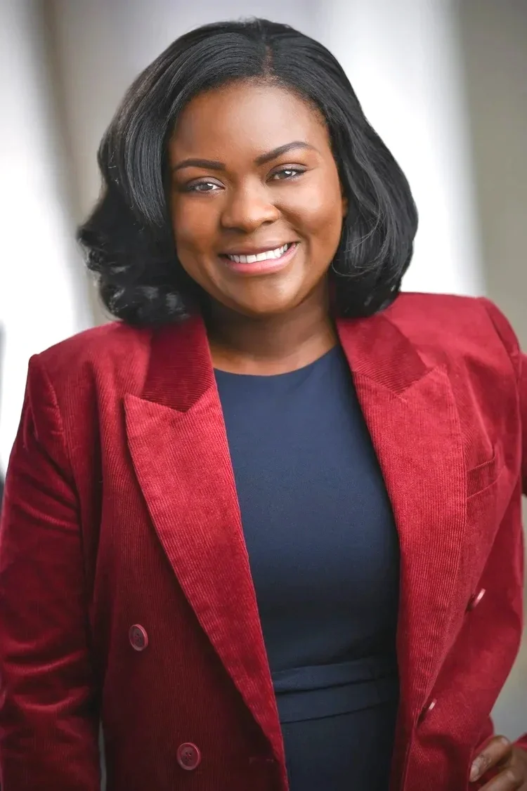 Woman in red jacket headshot