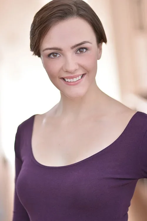 Woman smiling in purple shirt