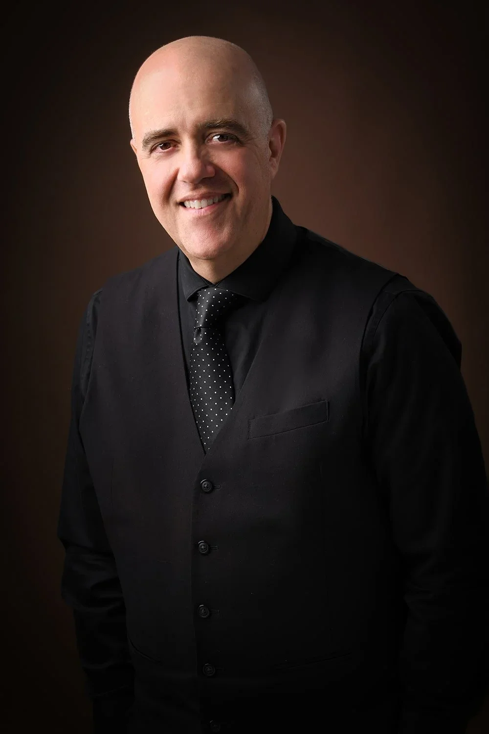 Man's headshot on brown backdrop