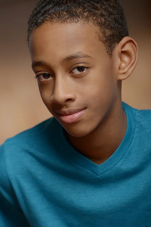 Kid in blue shirt headshot