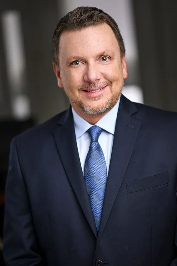Male in blue suit smiling 