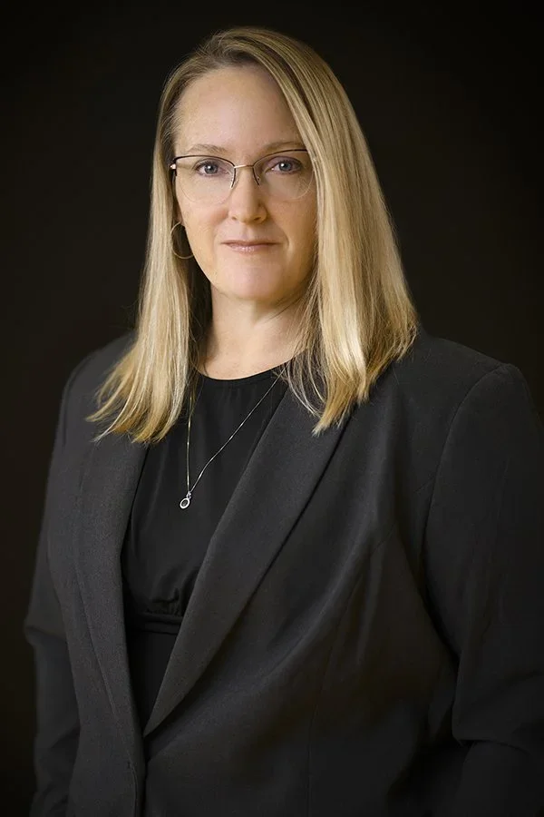 A headshot of woman in glasses