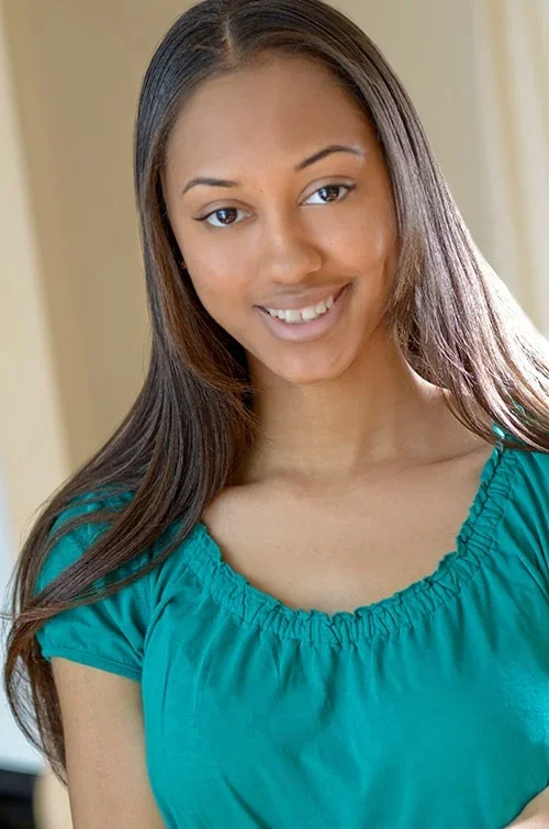 Female teen in green shirt headshot