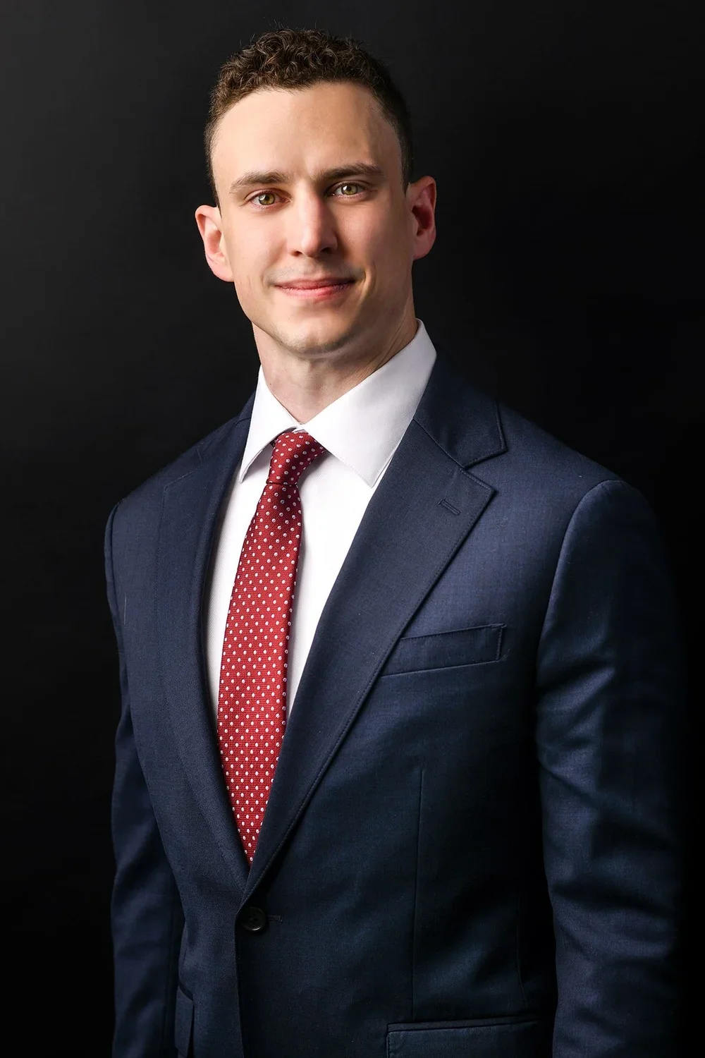 Cooperate headshot of a male on backdrop
