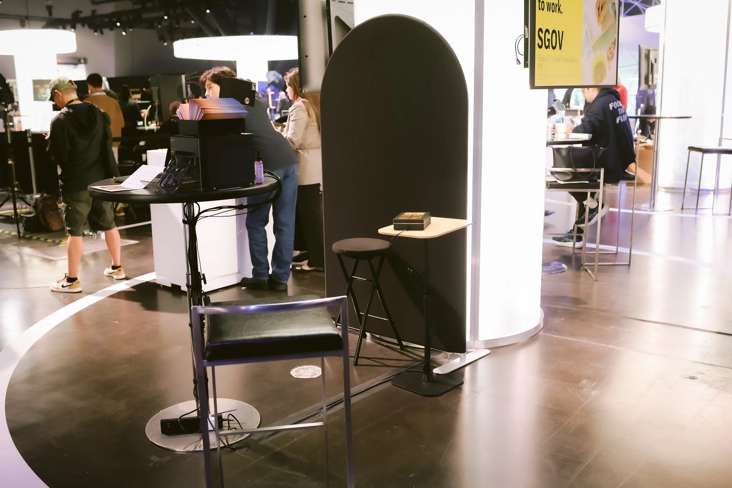 Compact Fox and Darling Aura photo booth setup with arched privacy backdrop on the HOOD Summit sponsor floor, next to iShares SGOV signage