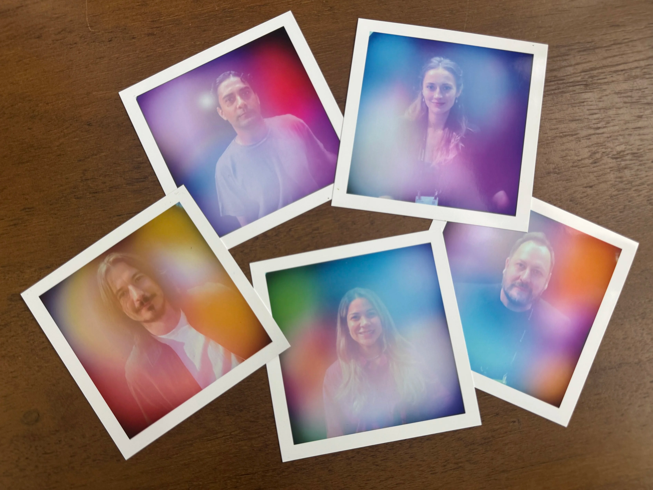 Four freshly printed aura portraits fanned out from the iShares booth at HOOD Summit '26
