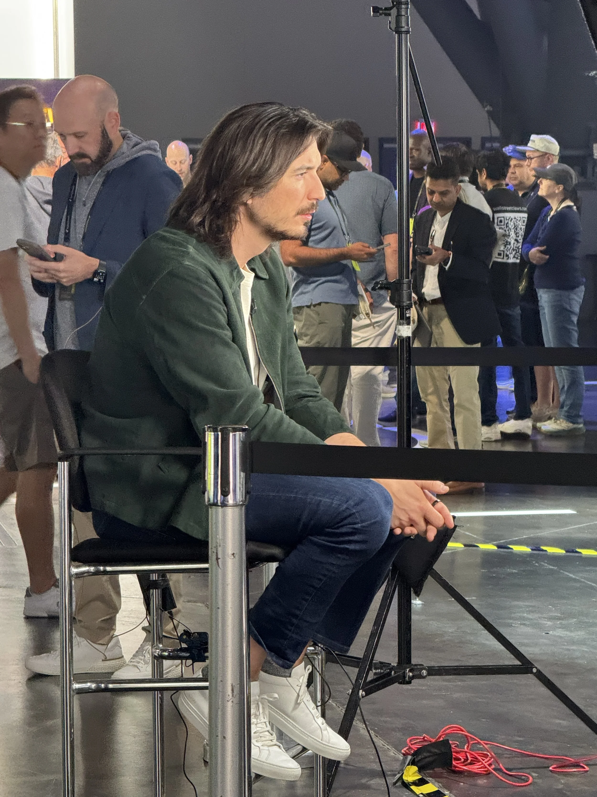 Robinhood CEO Vlad Tenev seated at the Aura biofeedback sensor station getting his aura read at the iShares by BlackRock booth, HOOD Summit '26