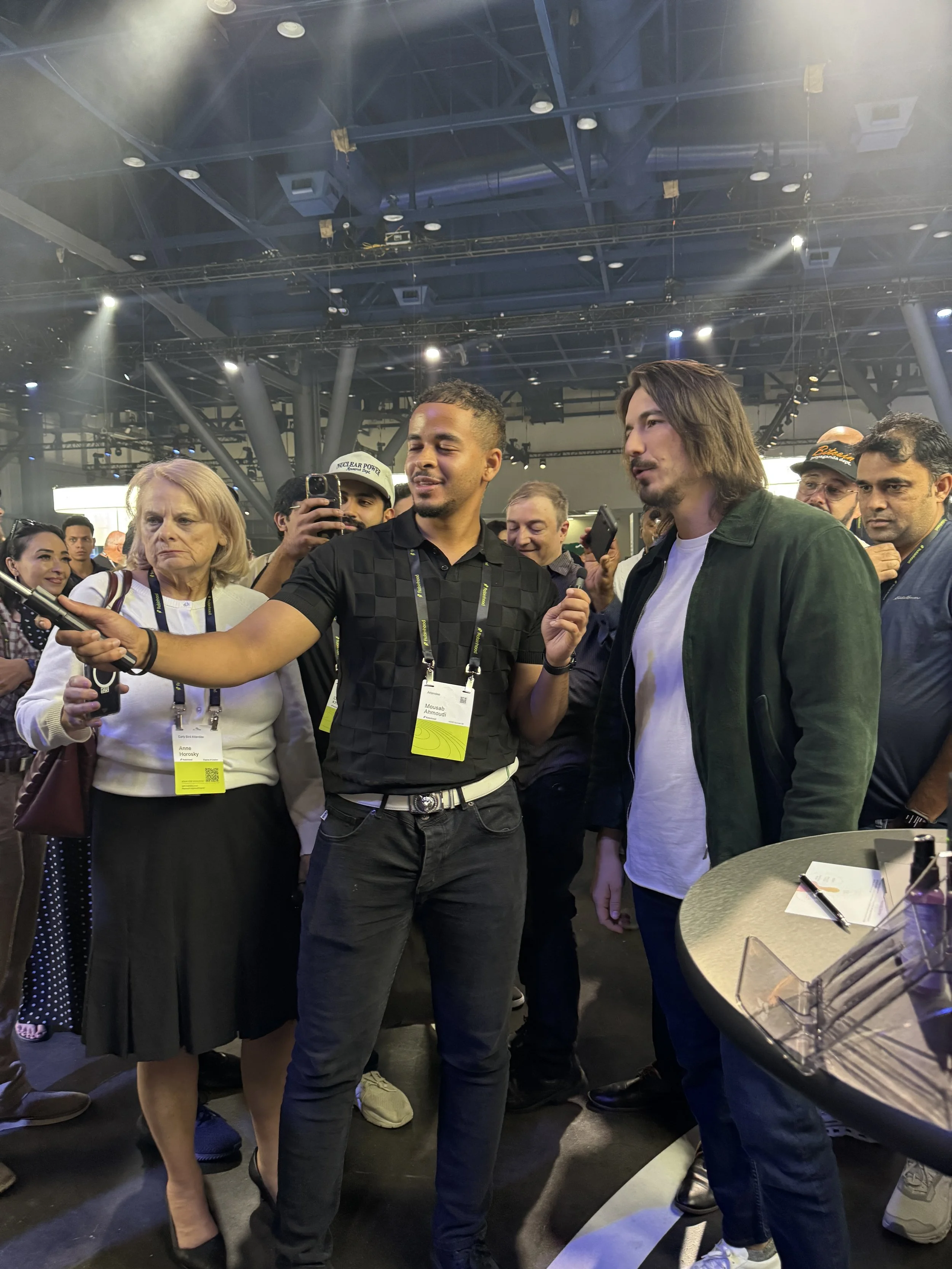 Robinhood CEO Vlad Tenev surrounded by a crowd of attendees at the Fox and Darling Aura photo booth activation for iShares by BlackRock at HOOD Summit '26