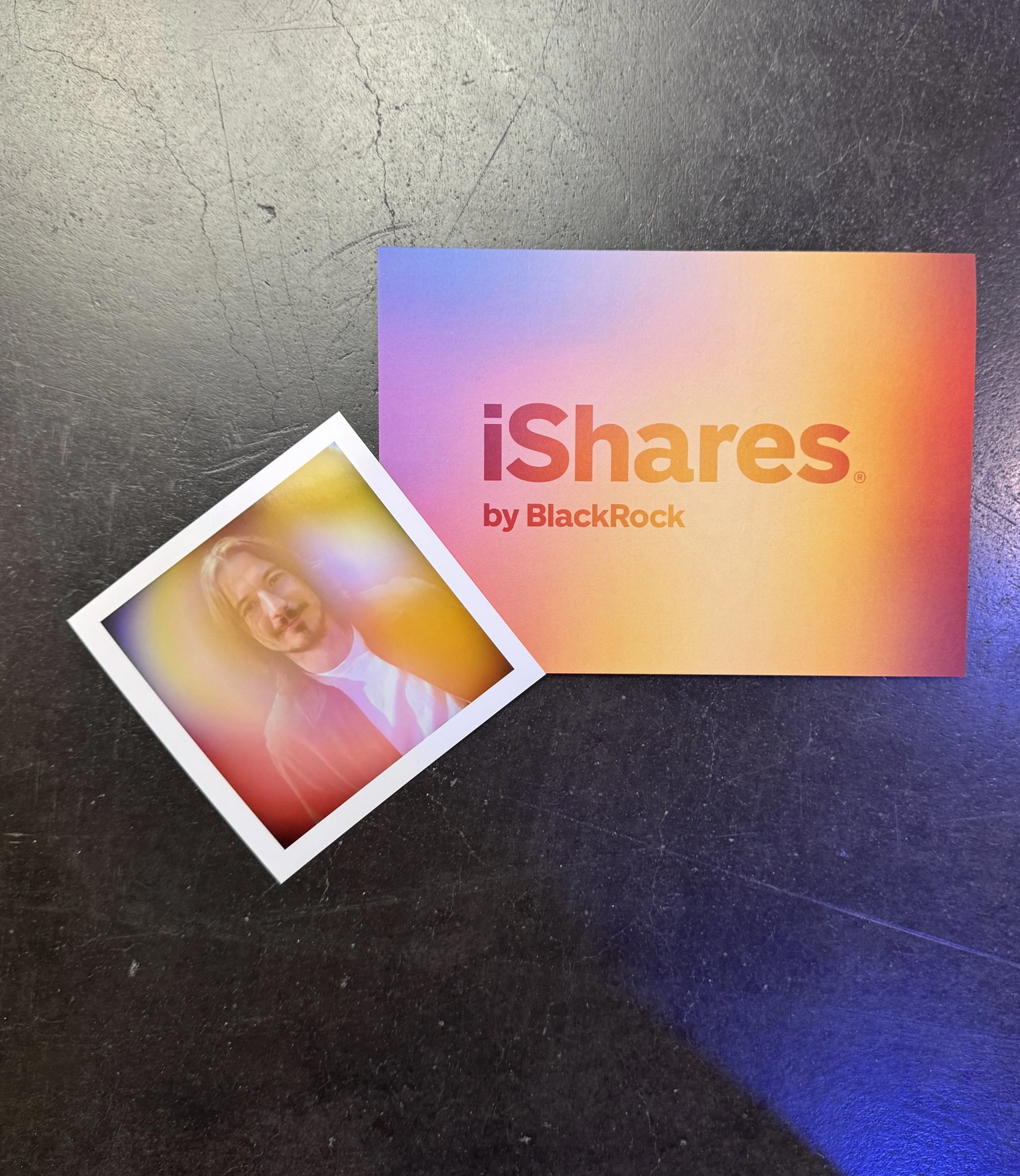 iShares by BlackRock branded card next to a printed aura portrait in the same sunset gradient, from the Fox and Darling activation at HOOD Summit '26