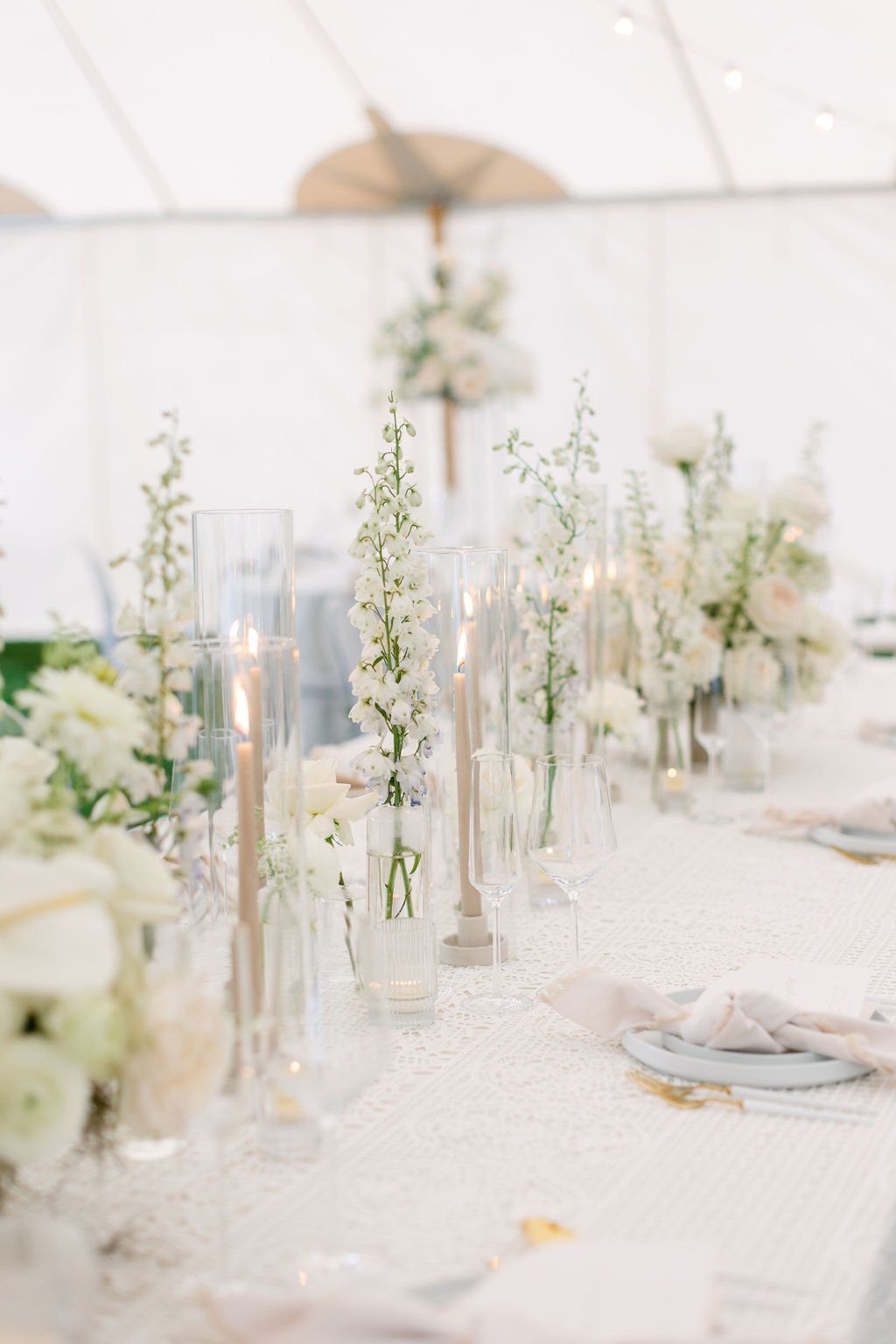 white florals table details outdoor wedding tent reception 
