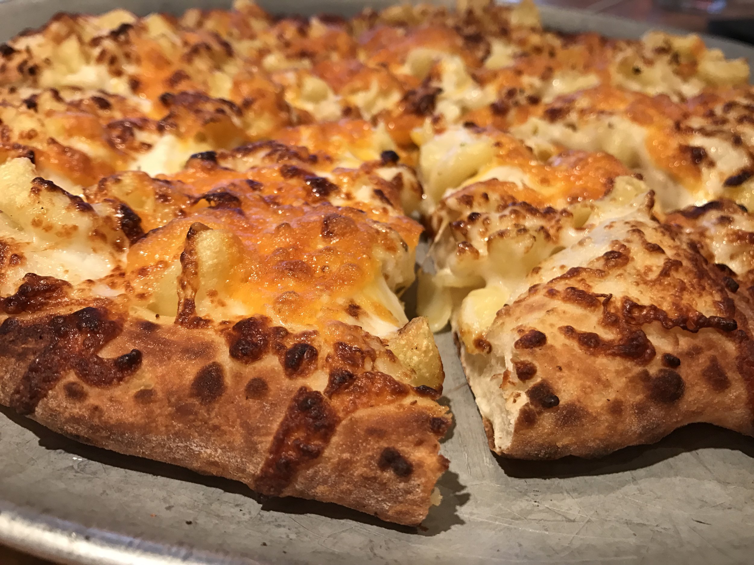 MAD MAC & CHEESE We weren't even trying to be cheesy with this one. It just turned out that way. But in all honesty, this pie is flat out delicious. Homemade mac & cheese topped on top of a fresh Alfredo base.