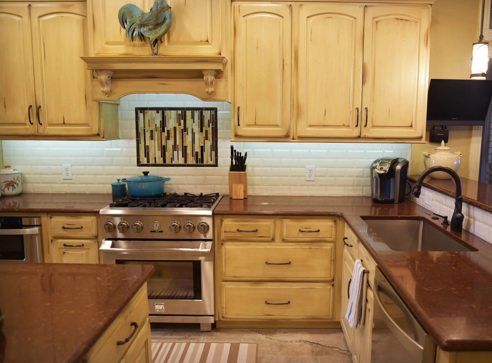 We provided the cabinets and countertops for this beautiful kitchen remodel! Shiloh Cabinetry: Olde World Finish - Cornsilk Countertops: Cambria Quartz - Burnbury™