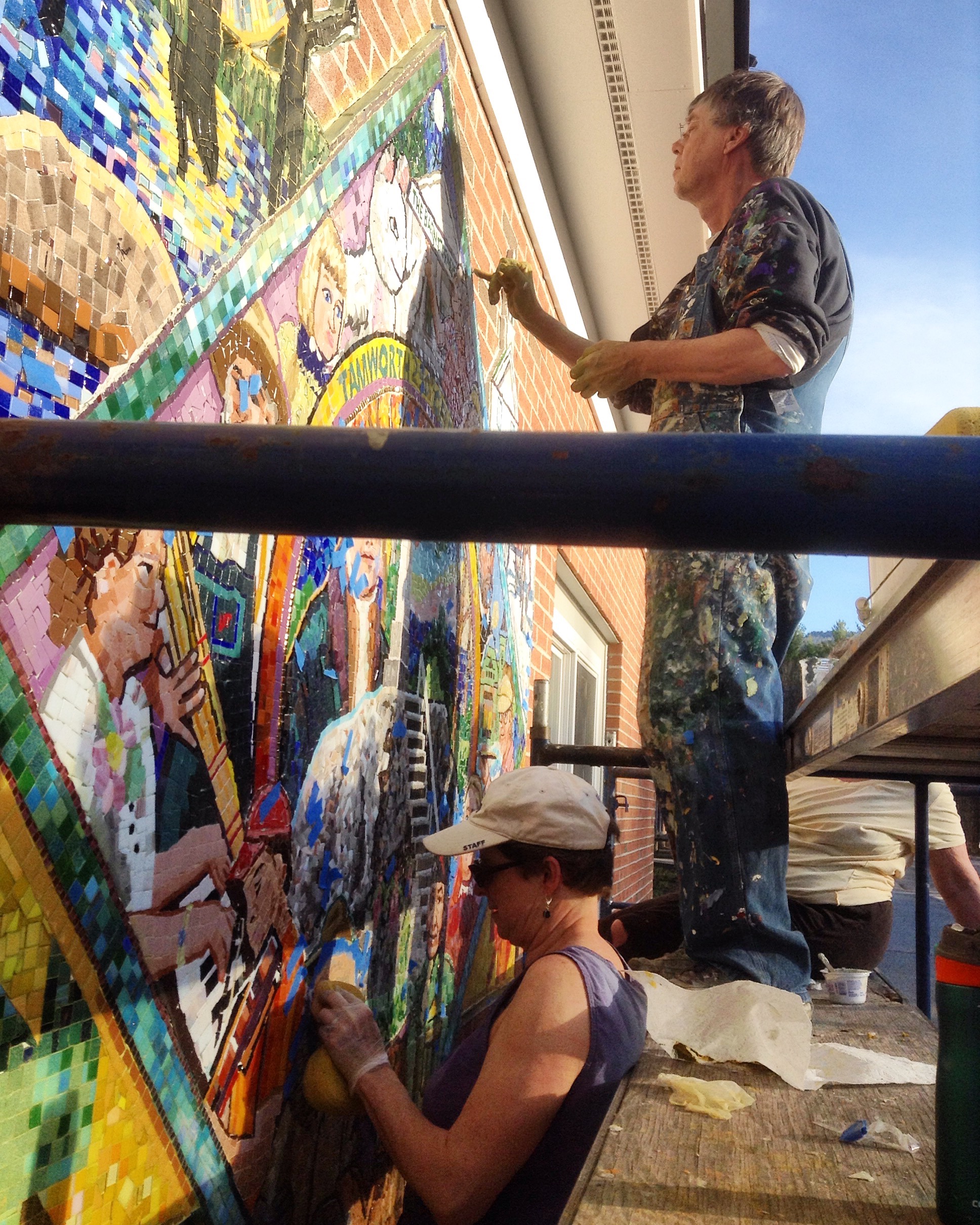 Cleaning up the second mosaic to prepare it for grouting.