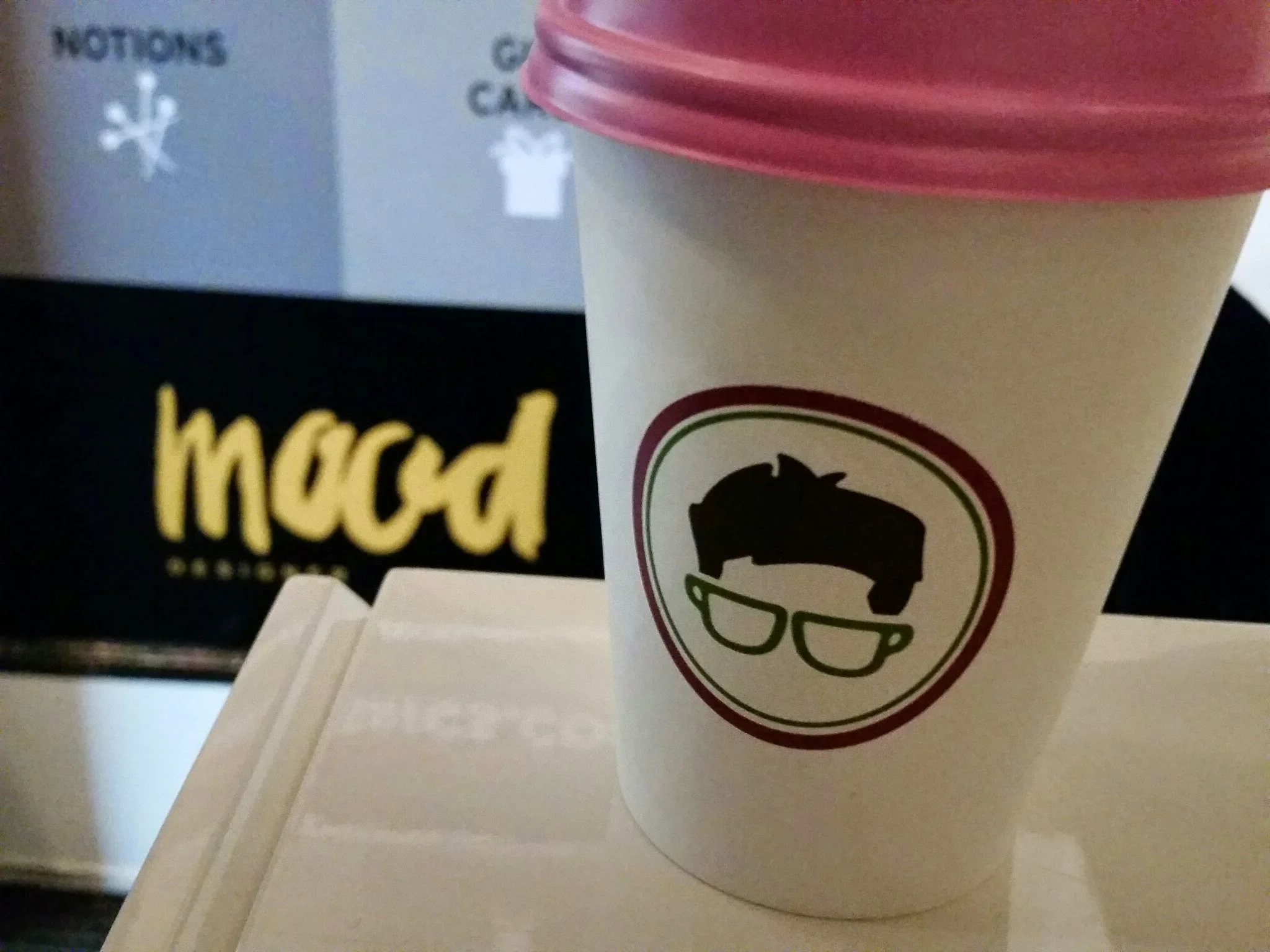 This is cup of Gregorys Coffee that gets you to the elevator that gets you to aisles and aisles of wholesale fabrics.