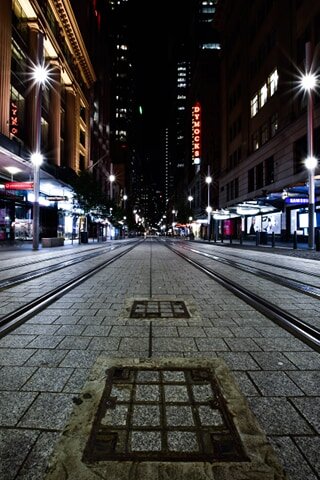 On George St, one of the busiest in Sydney, the only sound to break the whistling of wind lashing the buildings are from the horns of empty trams that pass by. Picture: Mark Kriedemann/Trademark Photography