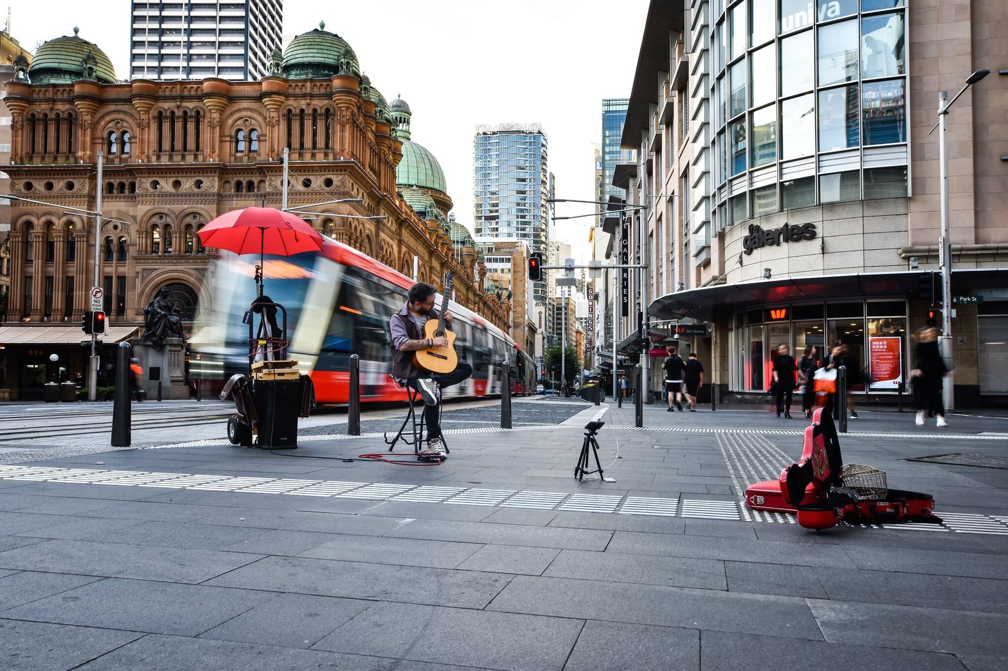 Back in the heart of the city the heave of people has become a trickle. Some buskers brave the bare streets to buoy the passers-by. Picture: Mark Kriedemann/Trademark Photography