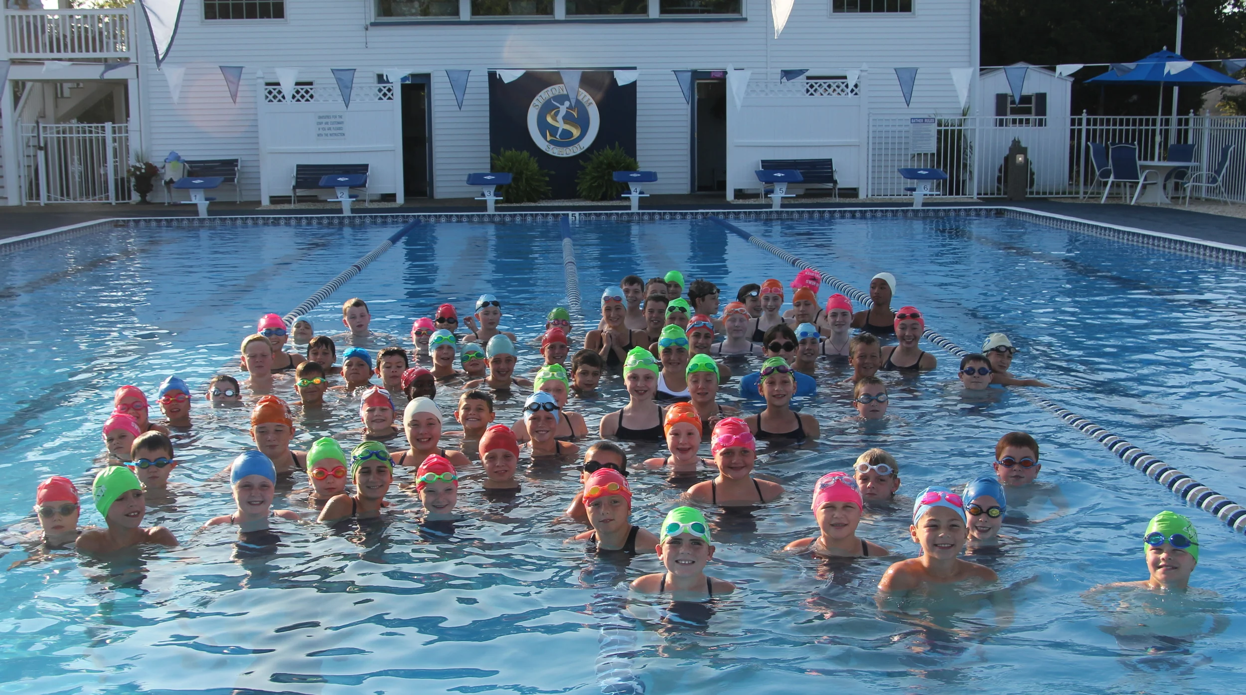 Silton Swim Team members wearing their Silton vs. Cancer caps!