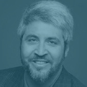 Corporate head shot of a man in a sports jacket.