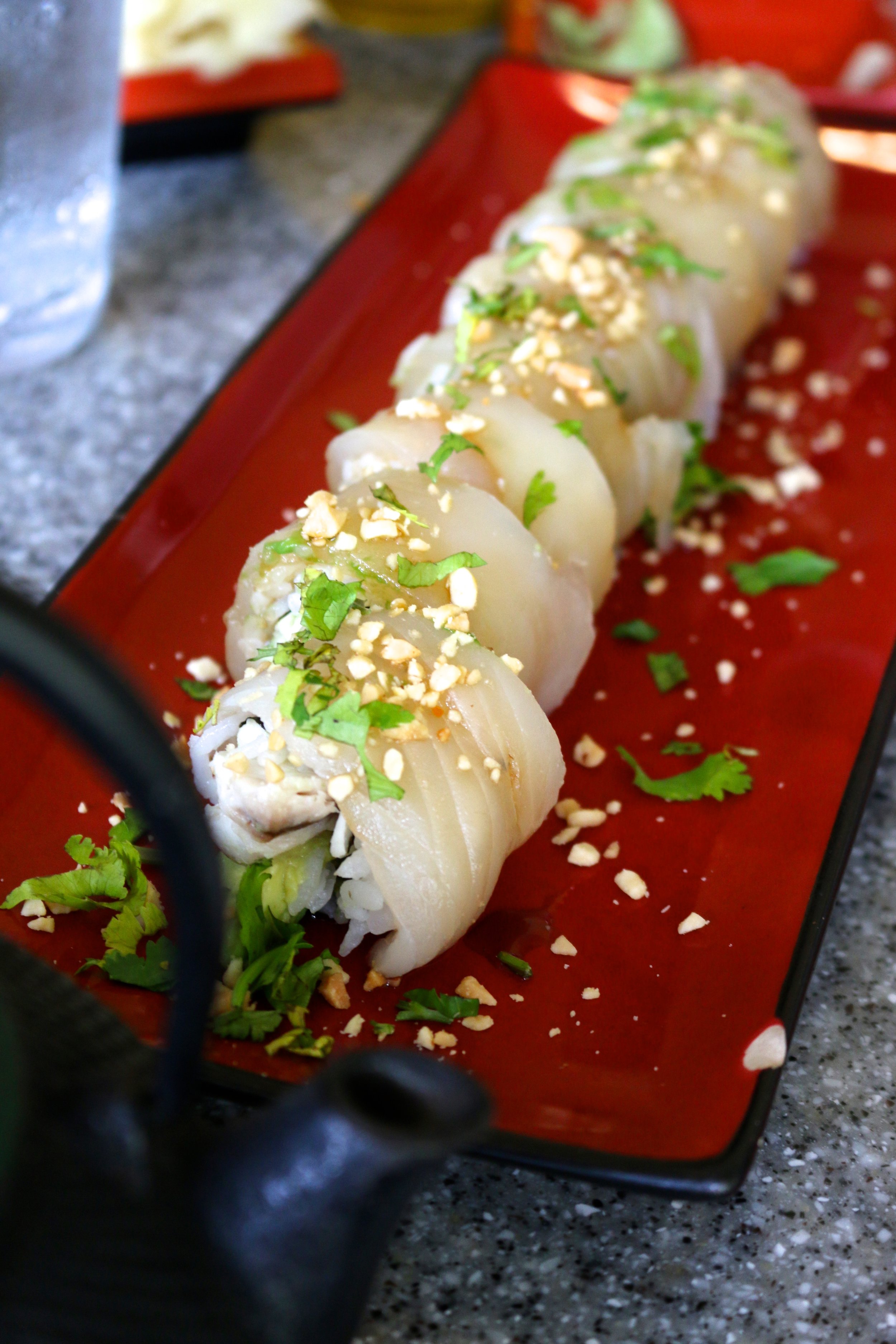 MING DYNASTY ROLL - sesame roasted fish, avocado, peanuts, cilantro, sashimi, and Szechuan sauce 