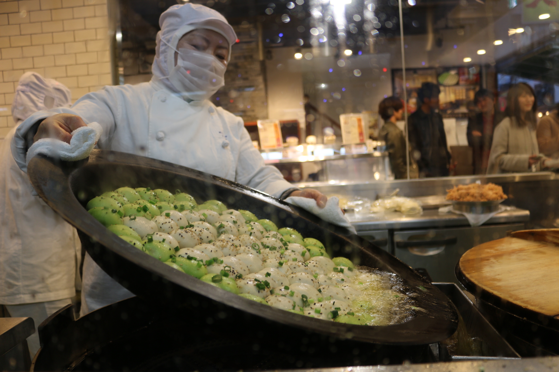 Steamed and fried fresh to order (green are filled with shrimp and white are pork)