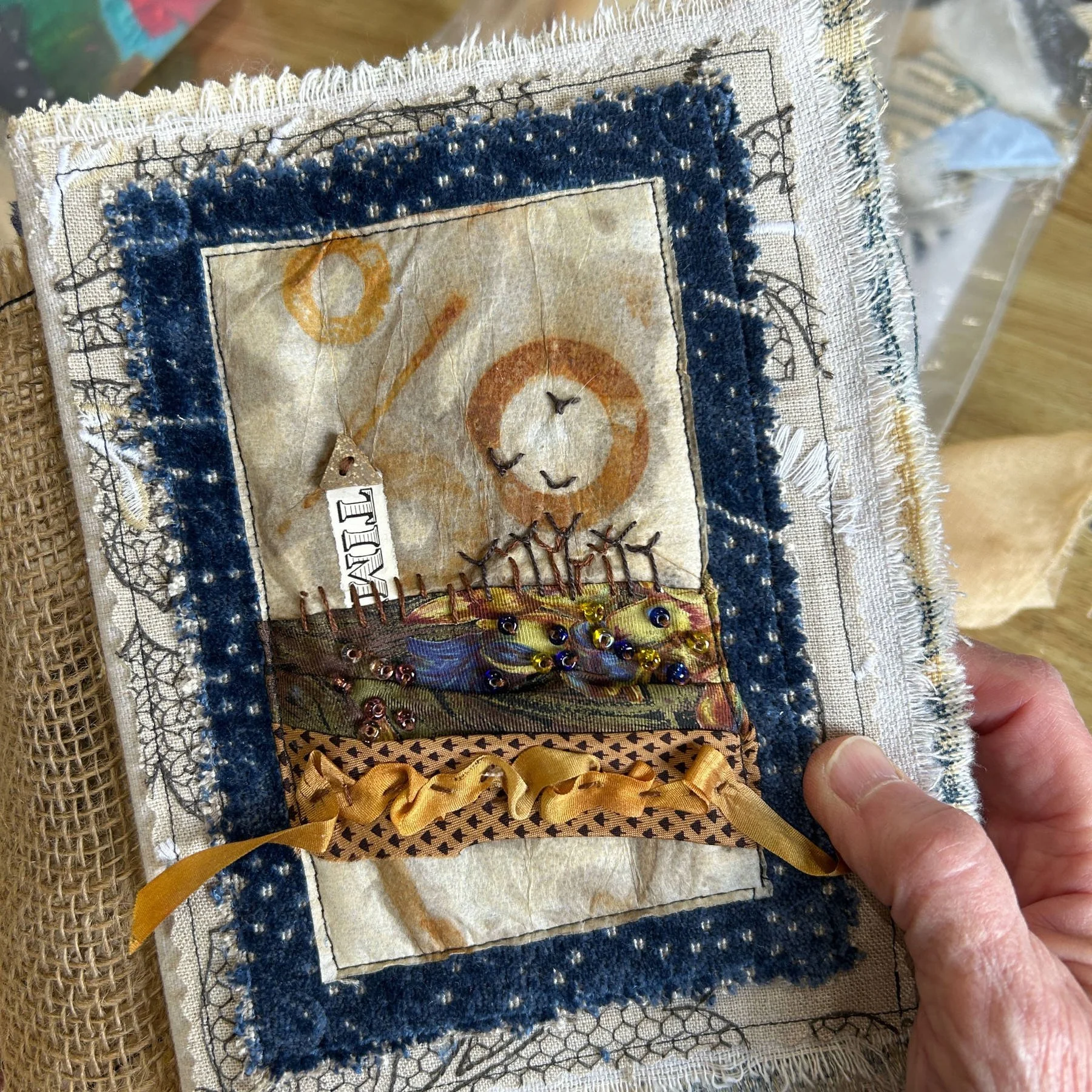 Rusted tea bag with fabric collage