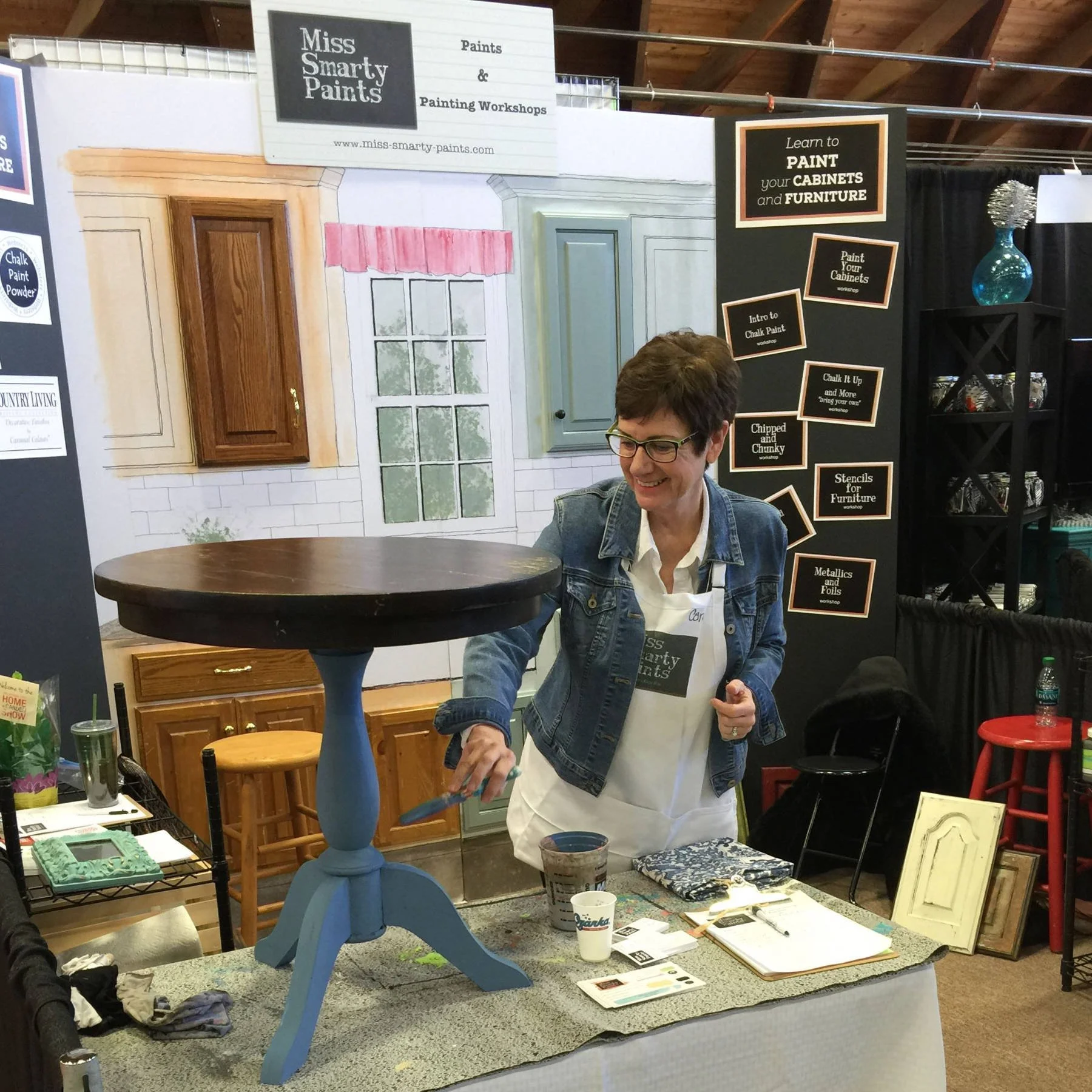 Carol Ann Webster in booth at home show