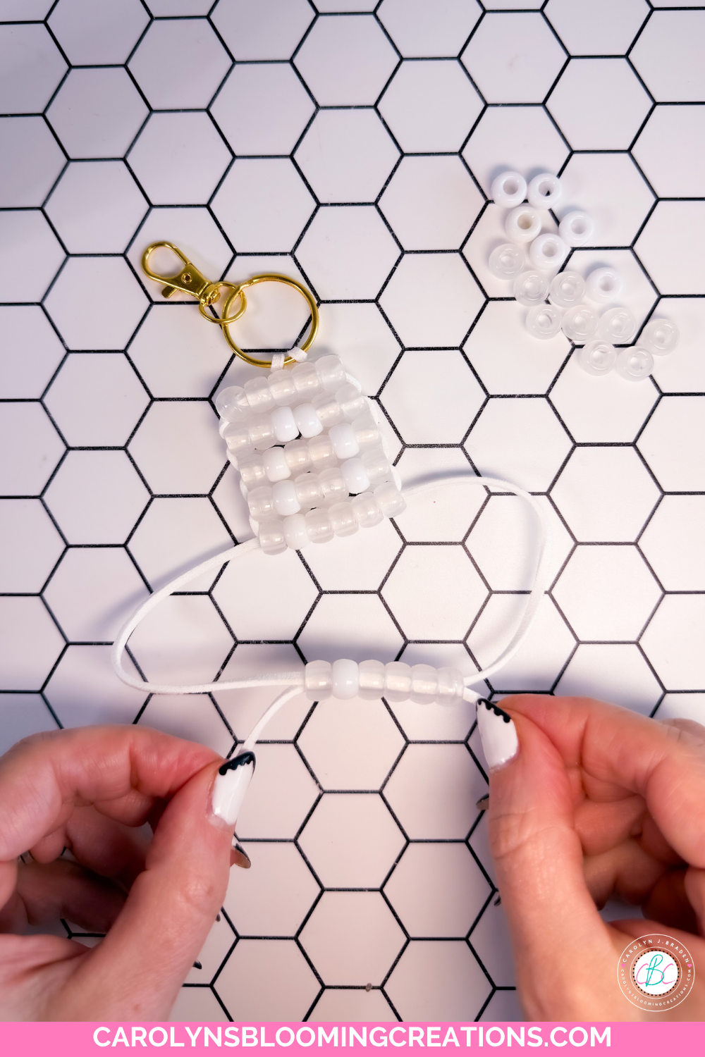 White pony beads arranged in a letter C pattern against clear UV color-changing pony beads to a bag charm