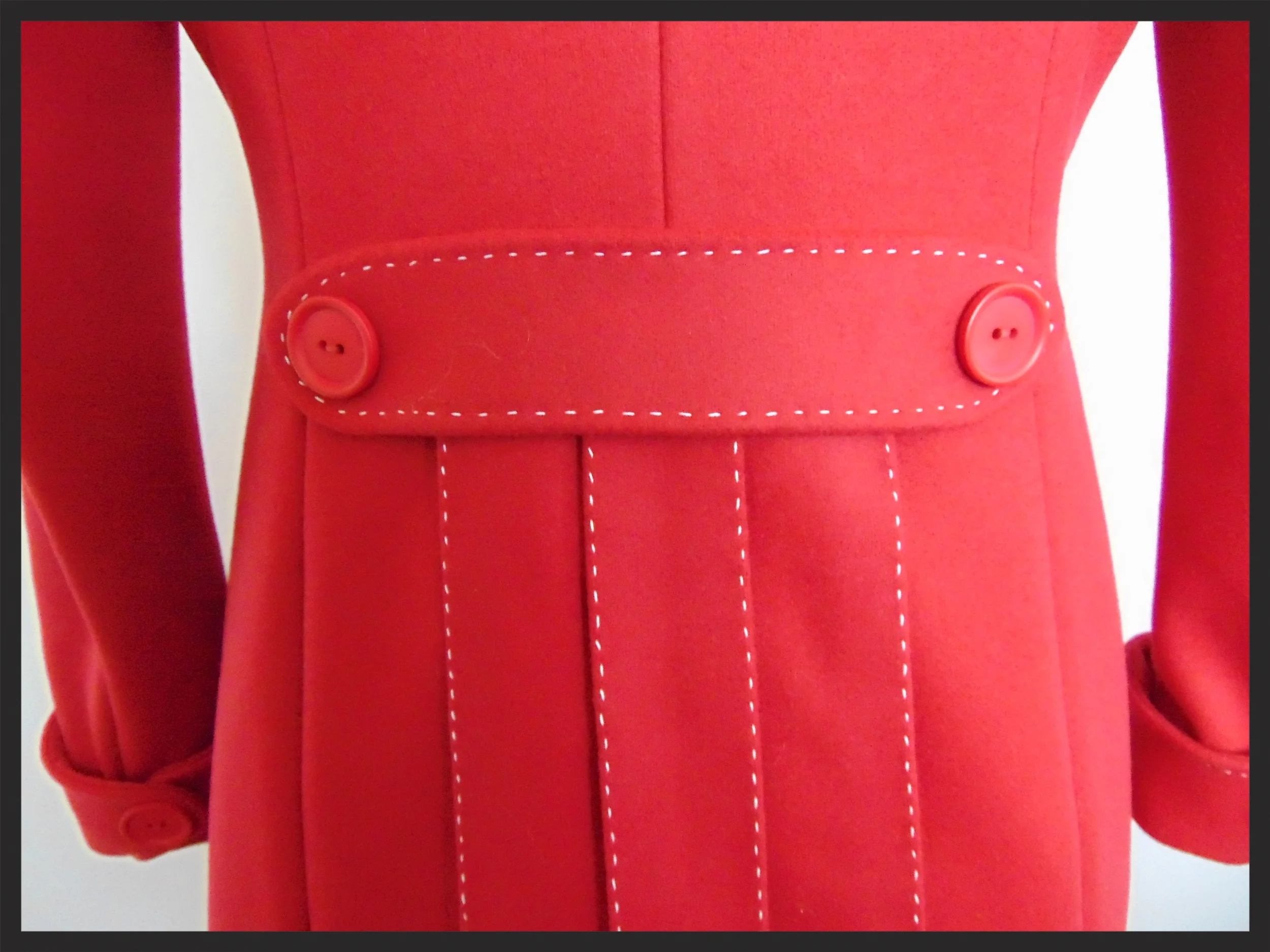  Close up detail of the back of the red wool coat. 