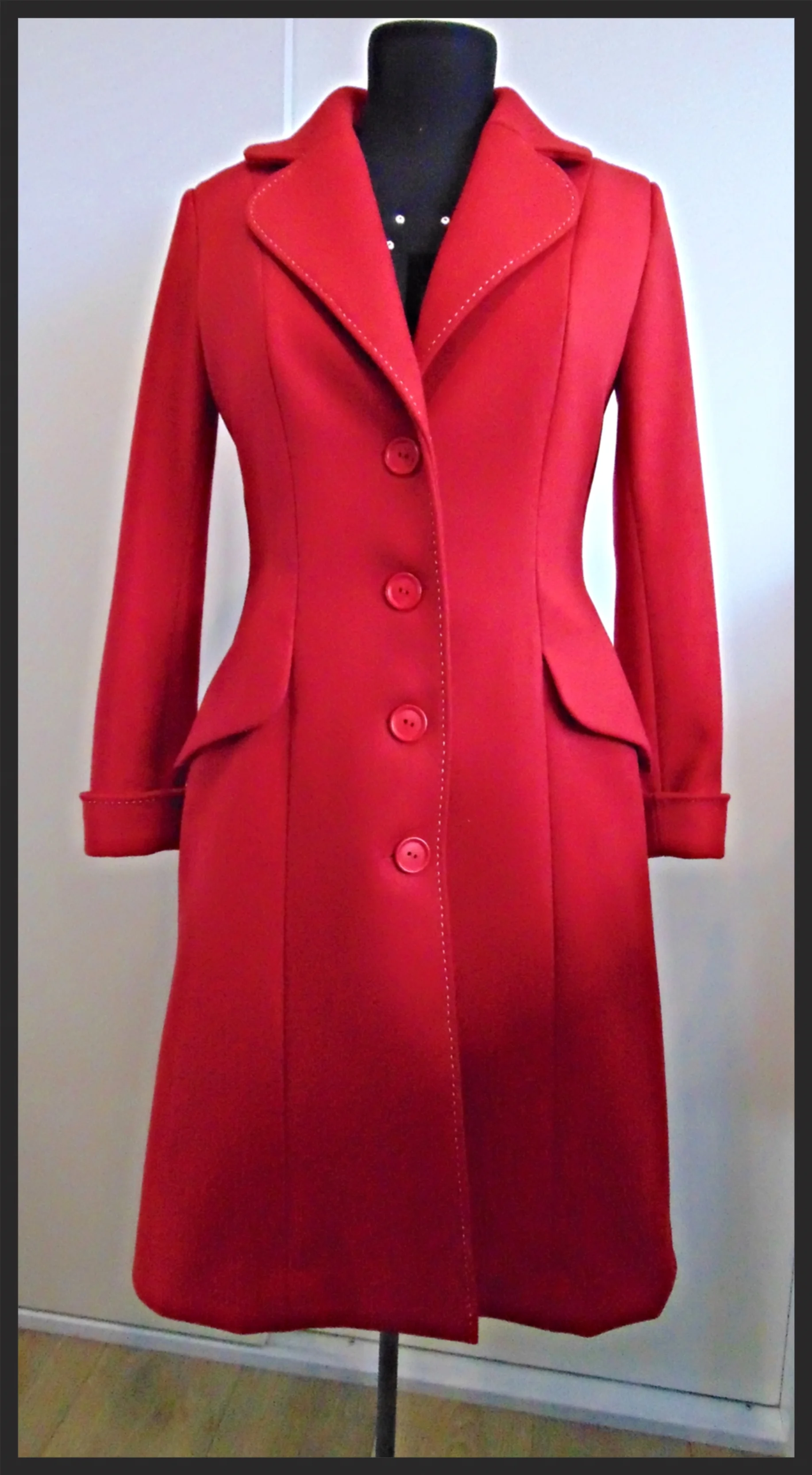  An example of tailoring by Kimberley. This coat was made from a stunning red wool and the edges were hand stitched in white thread for contrast. Elements of the design were inspired by the customers previous much loved, but worn out coat. We were ev
