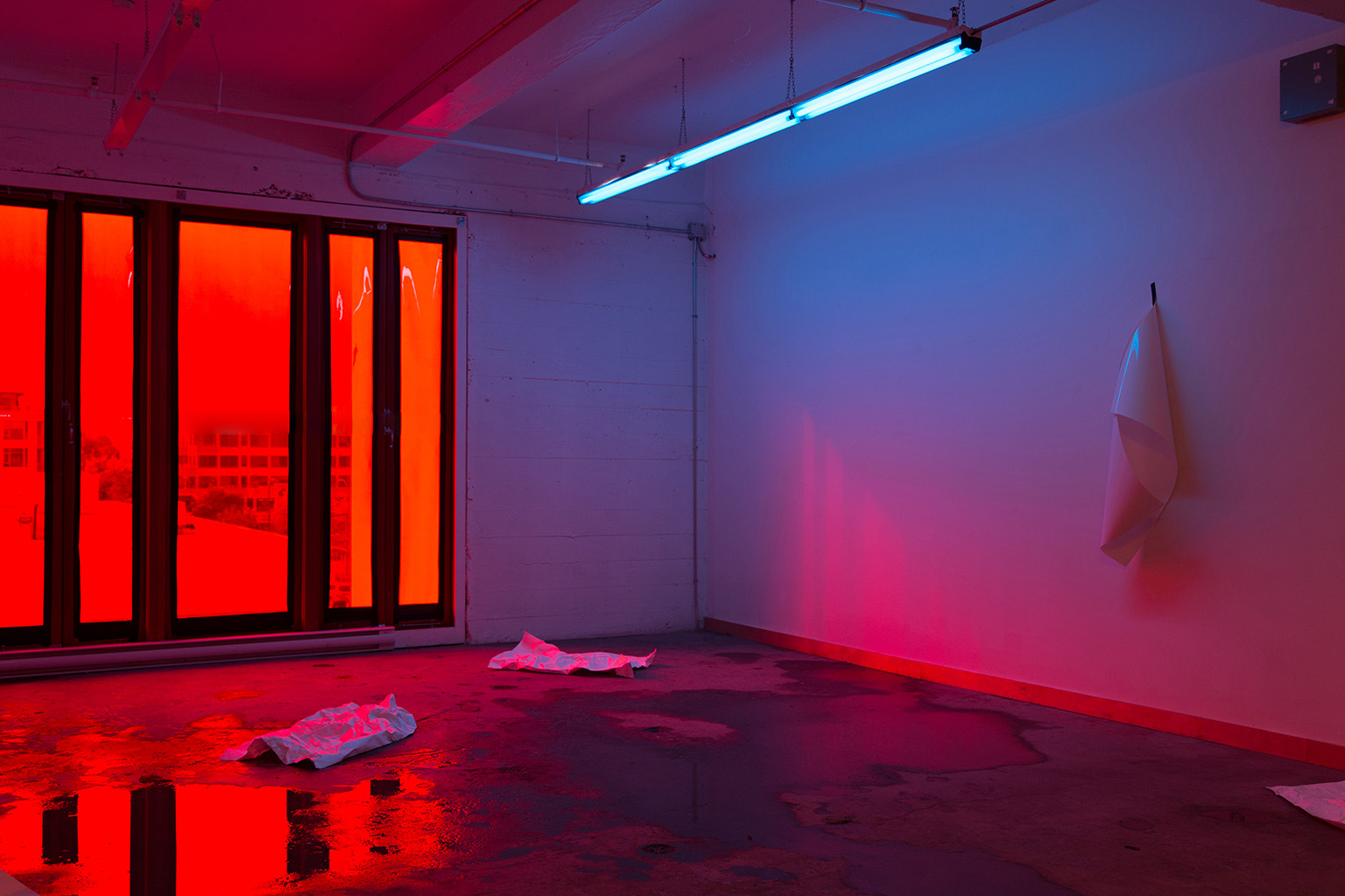   Photography Chamber, 2014.  Installation involving the&nbsp;flooding of gallery floors and subsequent&nbsp;evaporation&nbsp;of water,&nbsp;lighting gels, fluorescent lighting, ambient daylight and direct sunlight, tyvek, photographic paper, gaffer 