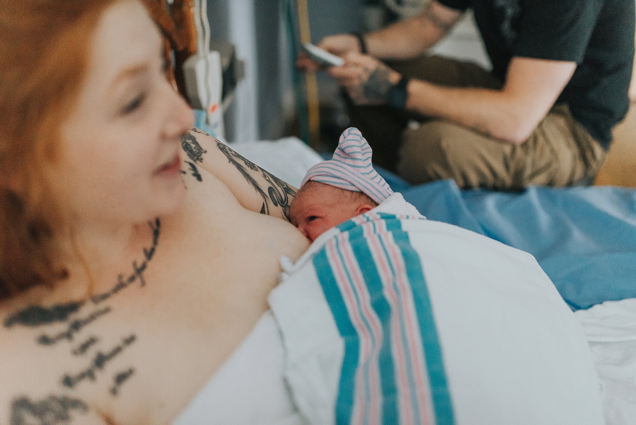 One of my favorite moments is in this photo. Baby is happily nursing and already studying her mother, and Dad is in the background sending messages with the news that their healthy baby girl has arrived!
