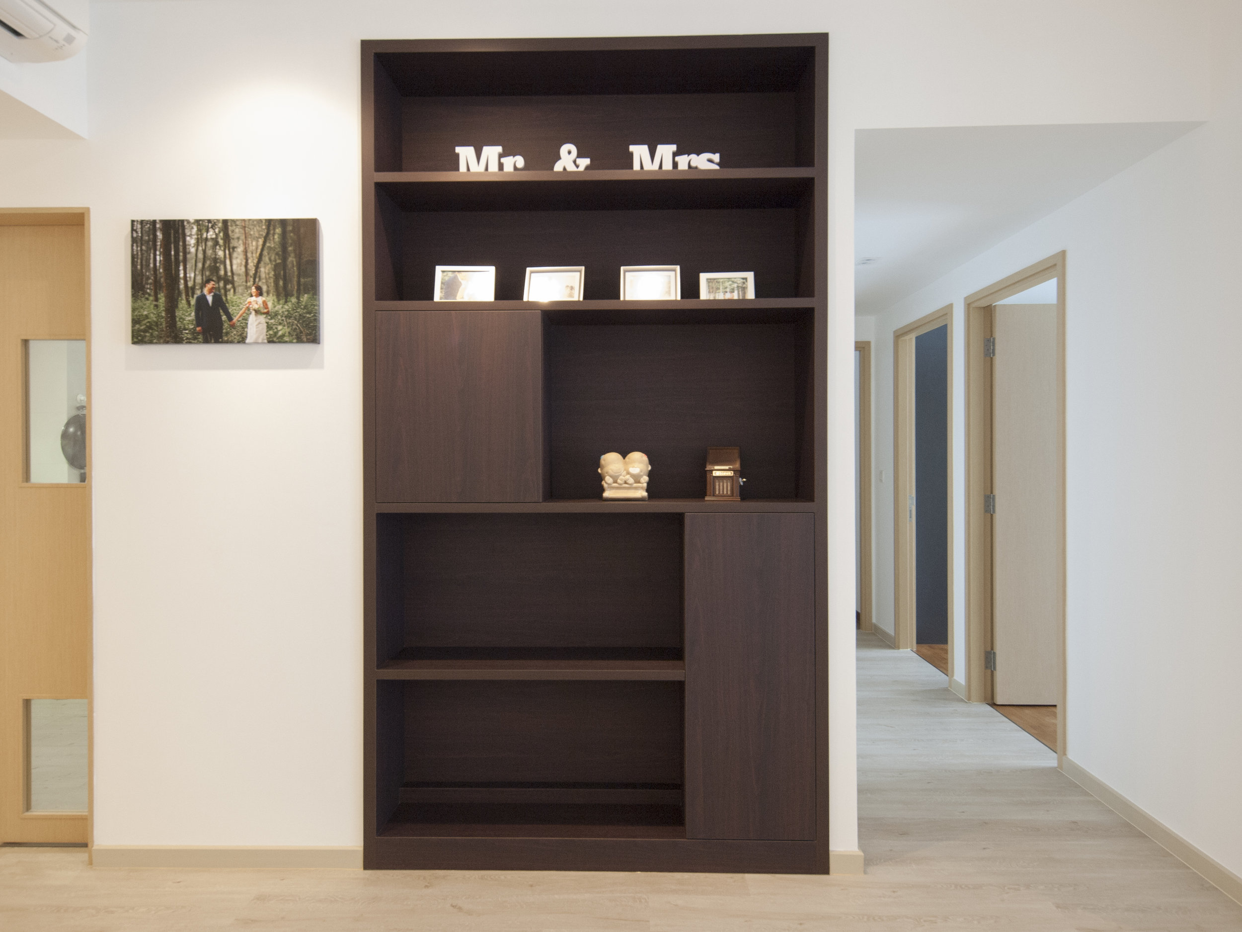 A large space was originally designated for the DB Box and modem. To optimise the use of space, this was transformed into a shelving cabinet for storage and display, concealing a good amount of electrical trunking and other electrical components while acting as a feature piece.