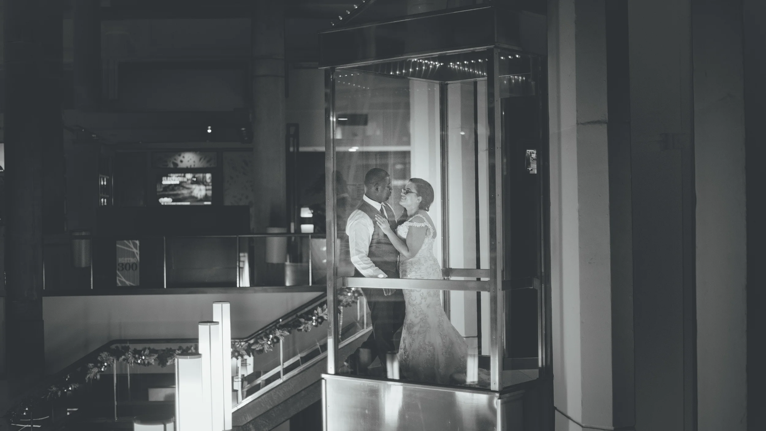Jasmine and Aaron take a break from dancing to share a moment alone in the Inner Harbor Hyatt's famous all glass elevator....I was there to sneek a photo...or two...