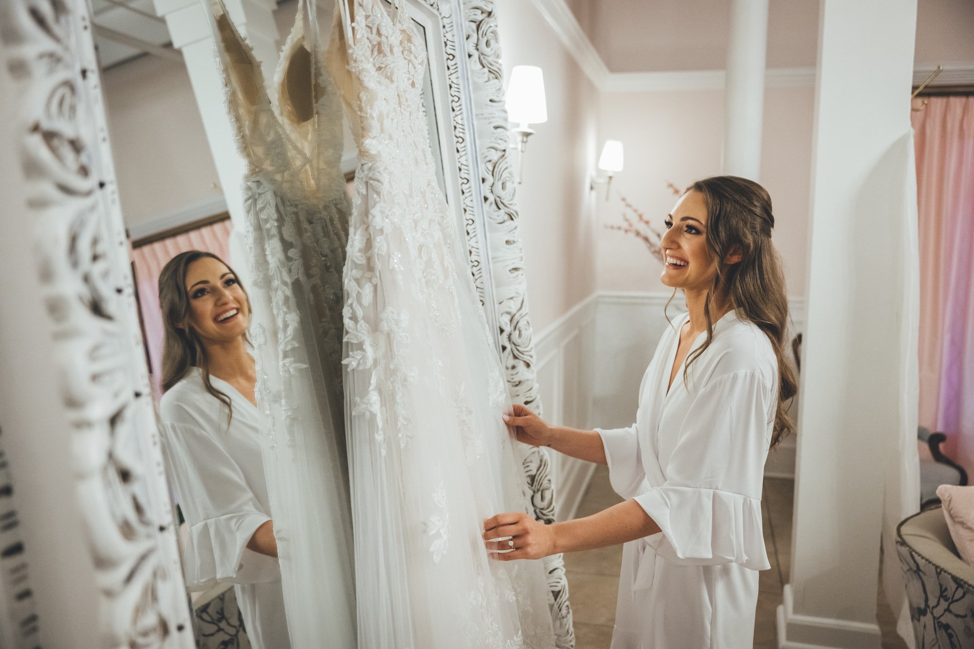 Bow Tie Photo & Video bride admiring her wedding dress at The White Room in St. Augustine, Florida.jpg