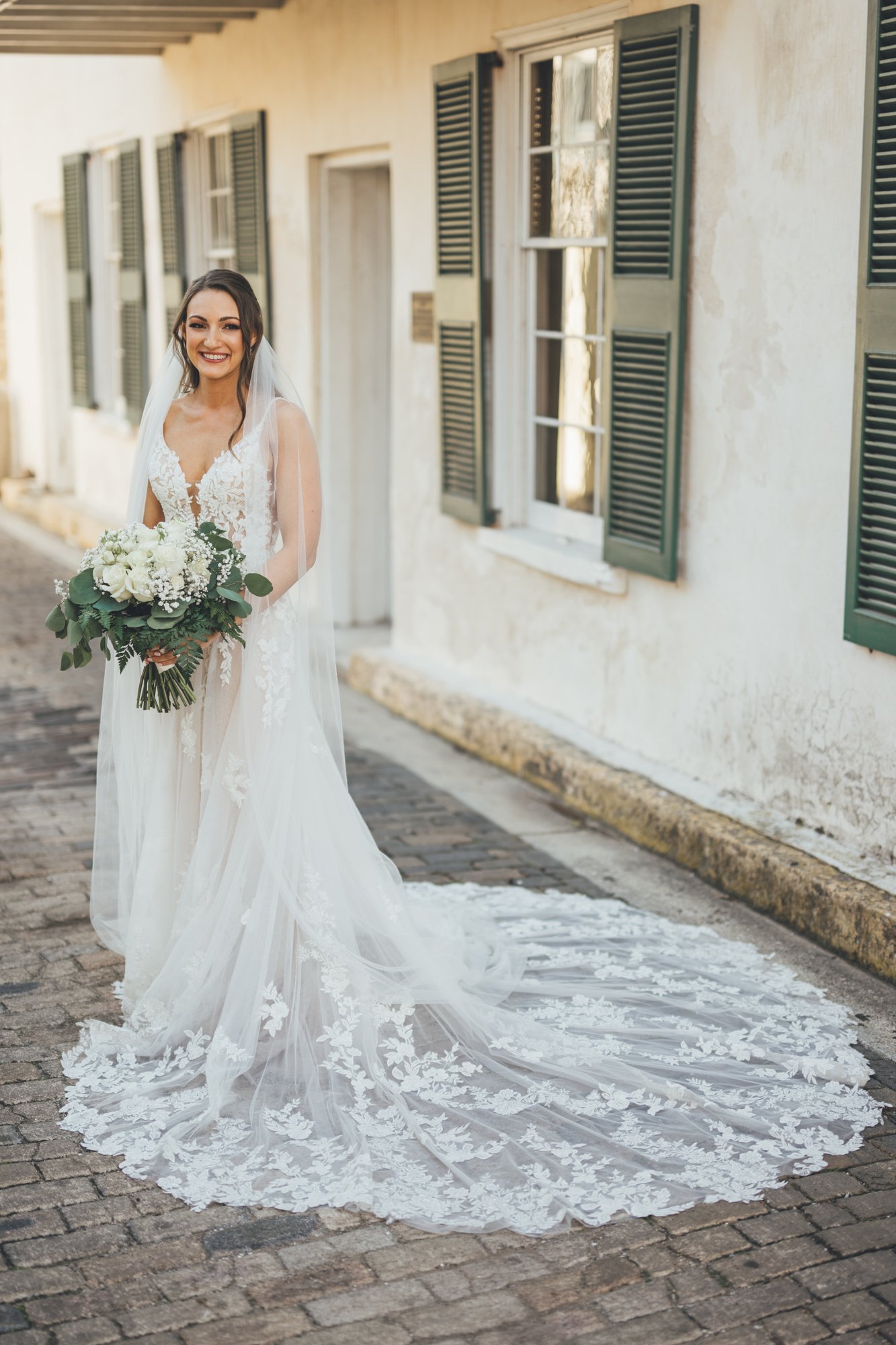 Bow Tie Photo & Video bride in her wedding dress in St. Augustine, Florida's historic alley.jpg