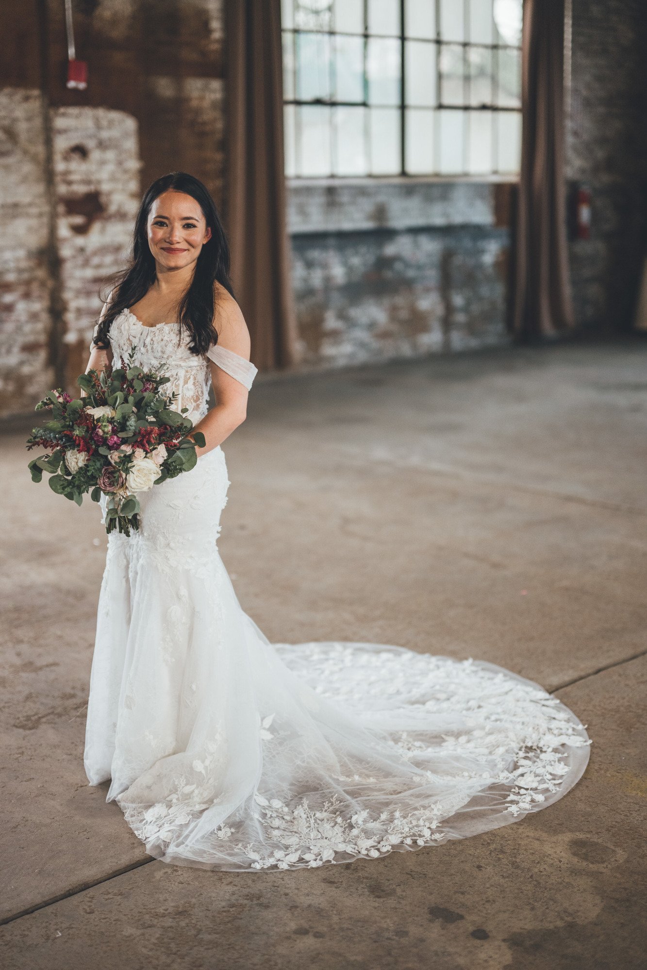 Bow Tie Photo & Video bride poses at The Glass Factory in Jacksonville, Florida ahead of wedding ceremony.jpg