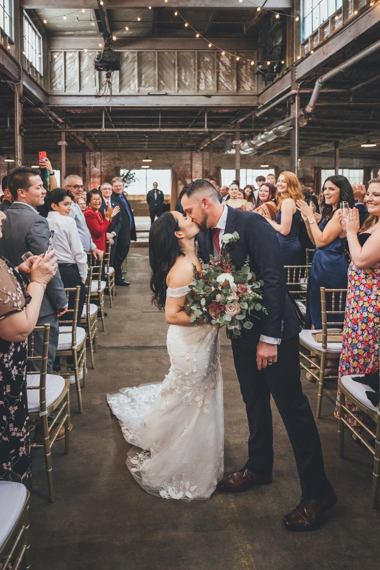 Second kiss as husband and wife following wedding ceremony at The Glass Factory in Jacksonville, Florida.jpg