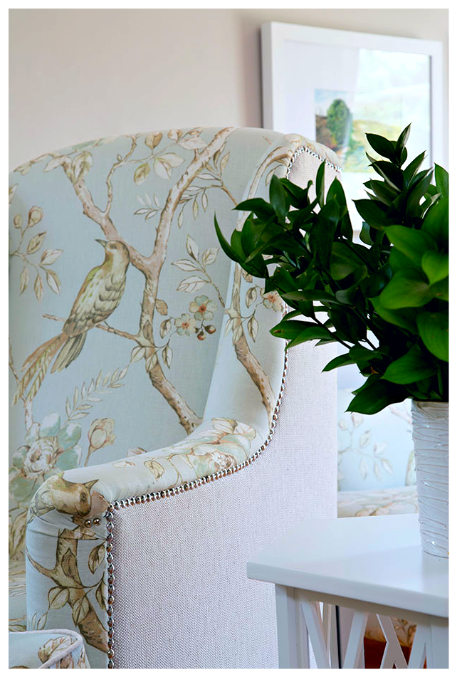 Beautifully upholstered armchairs featuring a plain fabric backing and pattern front.