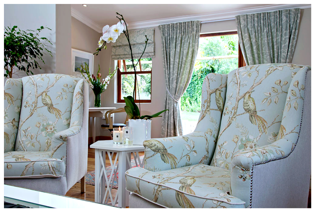 Custom pinch-pleat curtains and roman blinds in a coordinating shade of duck egg blue, Collection Andiamo in "Anastasia Spearmint", create the perfect backdrop to the room.