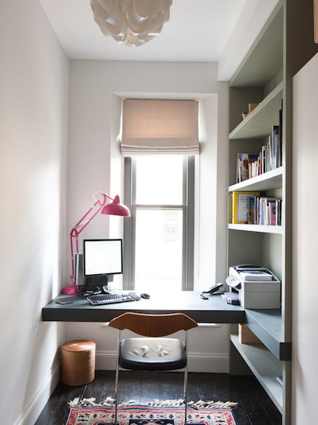 luxurious-home-office-with-built-in-desk-dark-wood-flooring-trash-can-white-pendant-light-built-in-shelves-desk-window-and-small-persian-rug.jpg