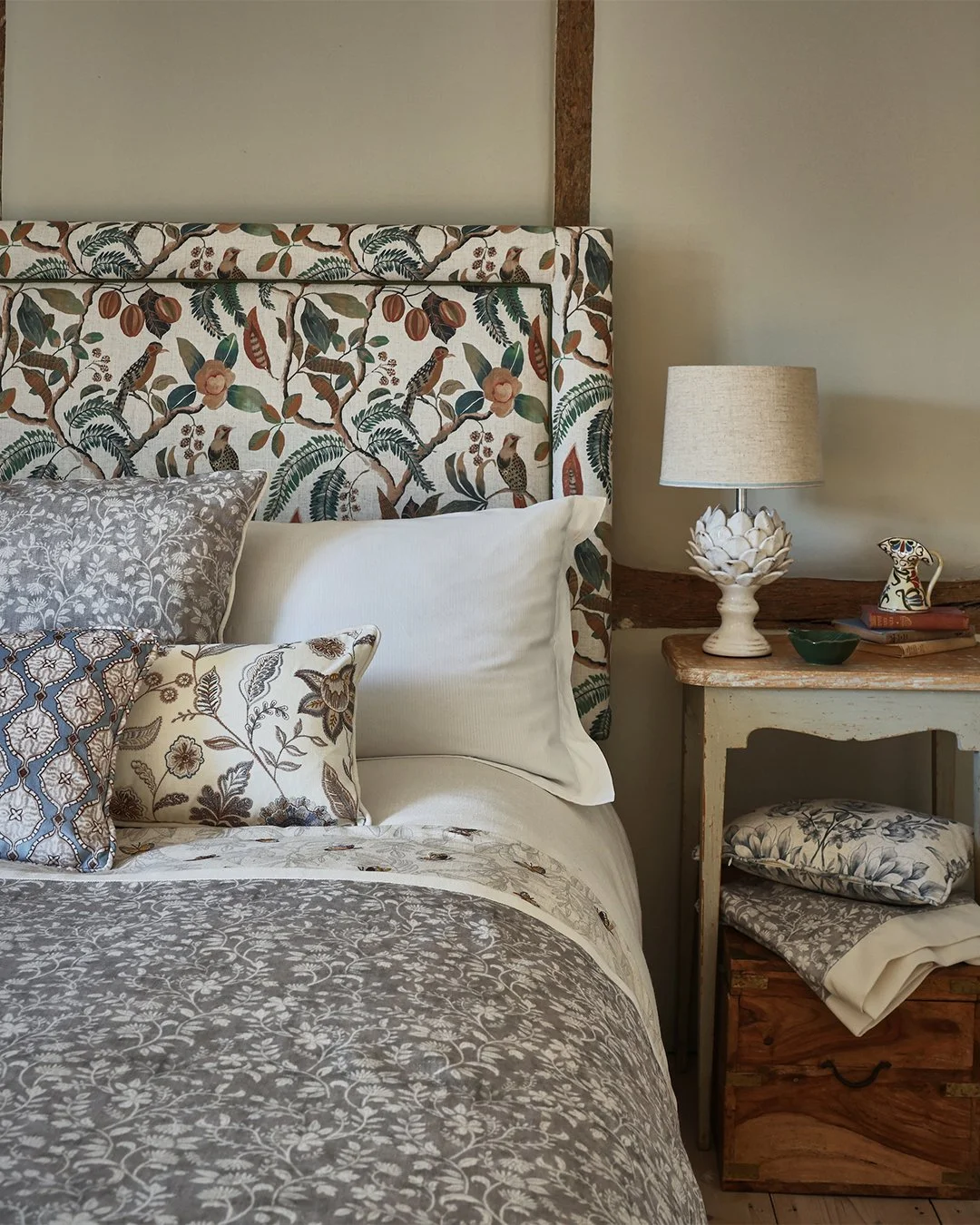 Create a serene bedroom scheme by mixing blue and brown hues through your fabric. Combine an upholstered headboard with coordinating scatter cushions in up to three or four of your favourite patterns and textures, for a soothing space that you can't