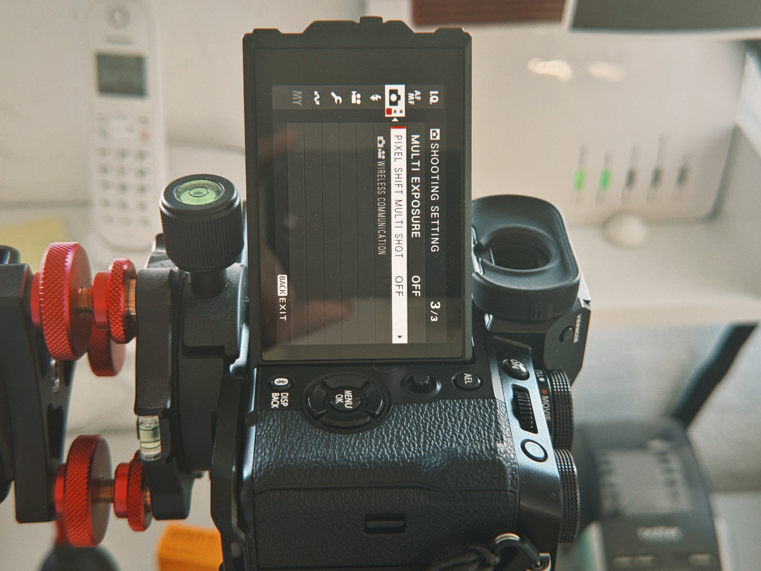 Fujifilm X-T5 mounted on a copy stand for film camera scanning with back LCD screen showing Pixel Shift option