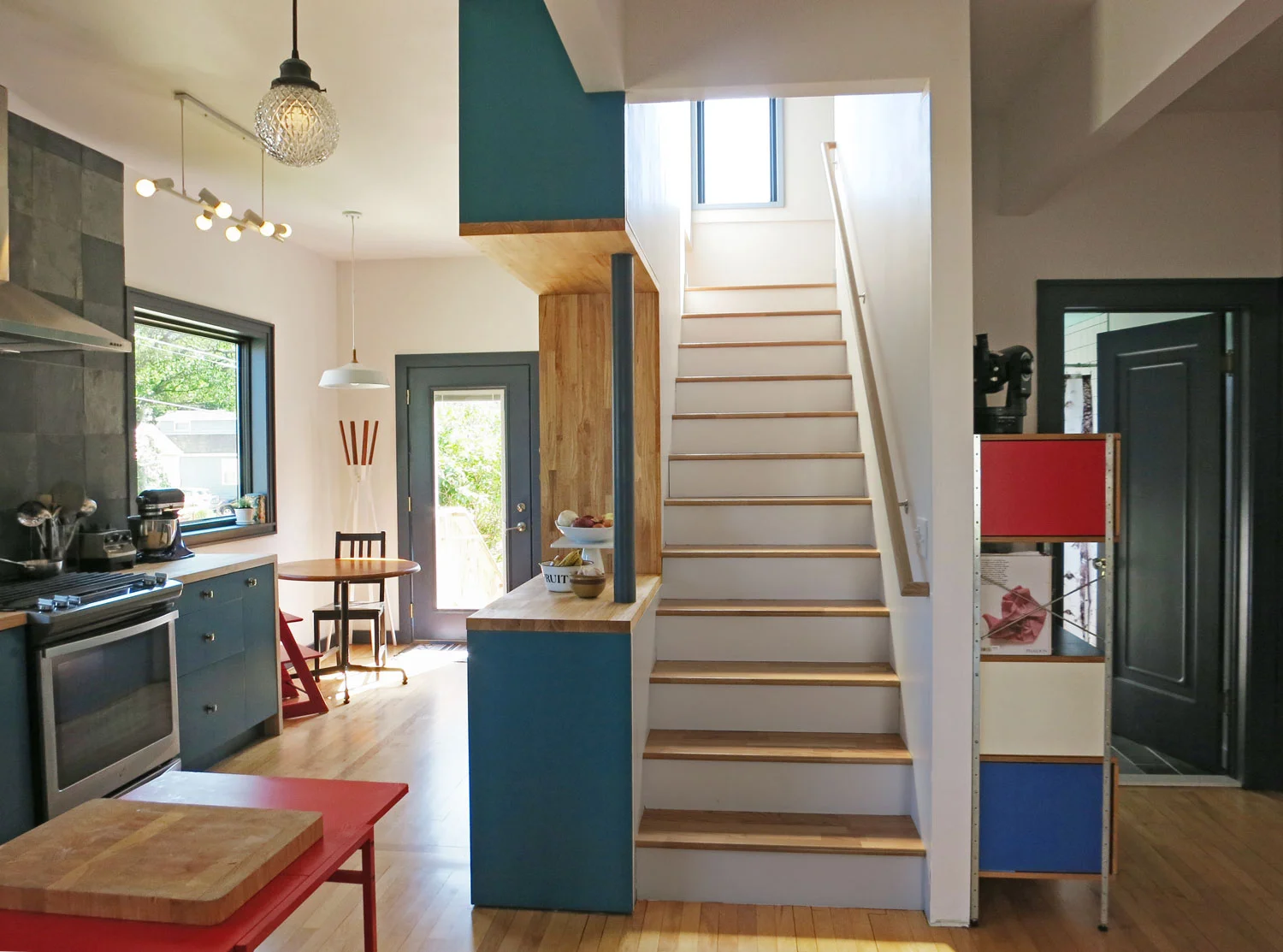 Centralized kitchen looking toward stair and breakfast area
