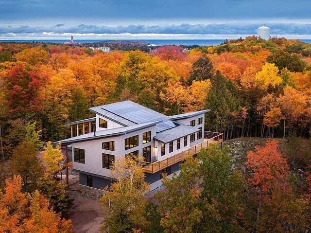 Bringing in the New year with our most recent completed project: a new home that takes advantage of 360 degree views of the lake and the city of Marquette through a series of decks, porches, and balconies. The dramatic roofline helps to provide the i