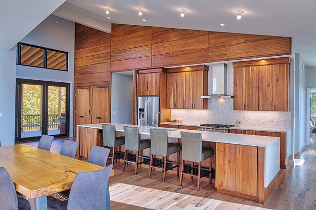 The warmth and character of this walnut kitchen anchor the lofty bright space of this modern home while the expansive island gives the family plenty of space to work and play.

Builder: Carr Construction
Kitchen by @schwalbachkitchens 
Counters by @s