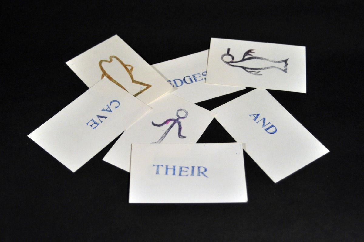 A set of cards with words on one side and symbols on the other representing Self Actualization.
