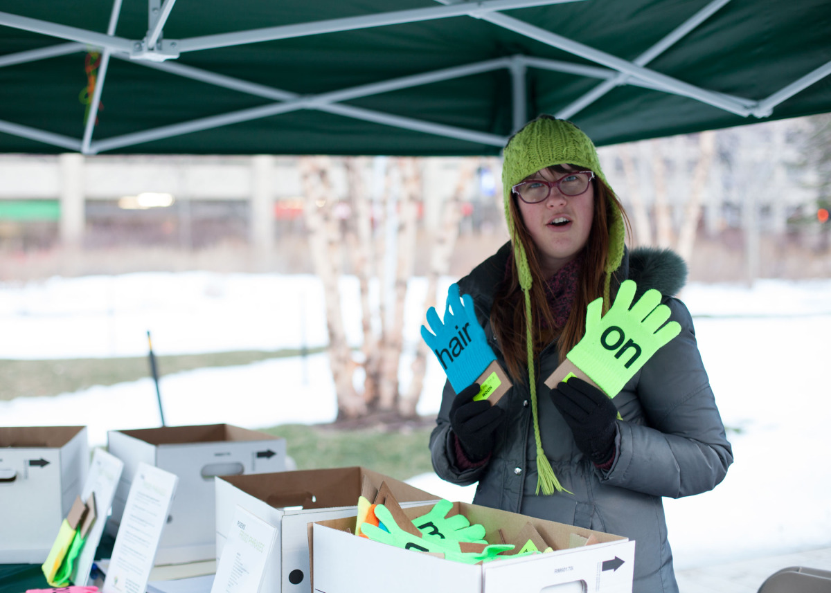 Volunteer Jess with boxes and boxes of extra gloves. Sometimes people came back to her to look for their favorite word and color combination.